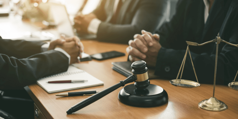 Lawyers talking at a table.